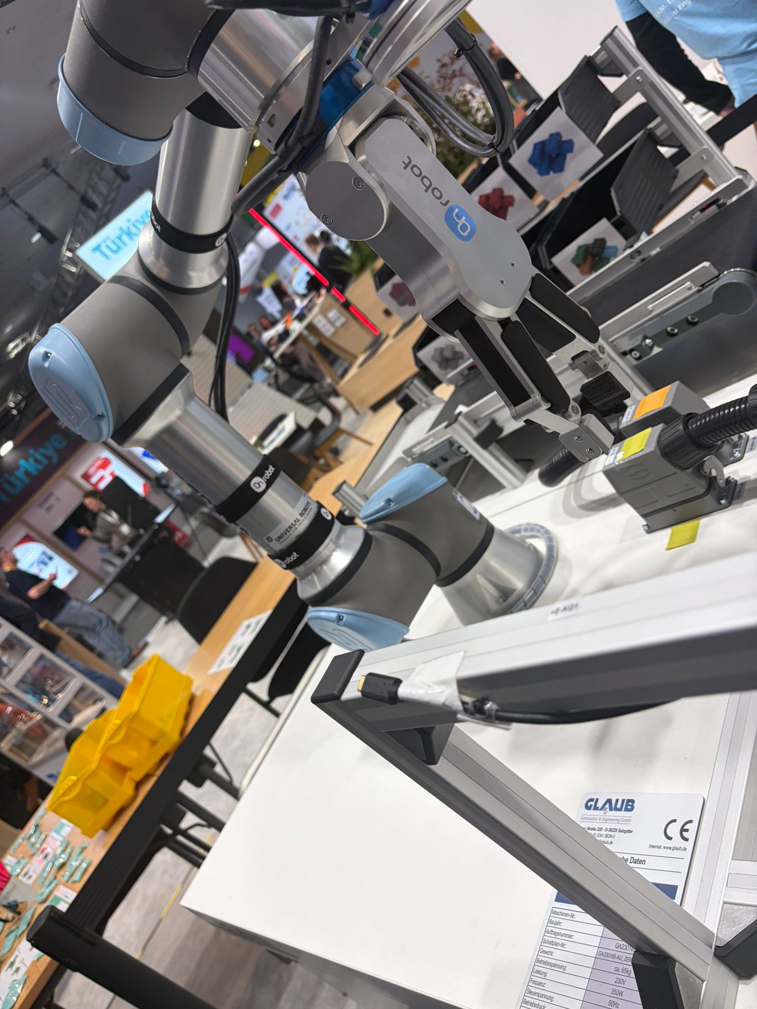 UR arm with Robotiq parallel gripper at university booth